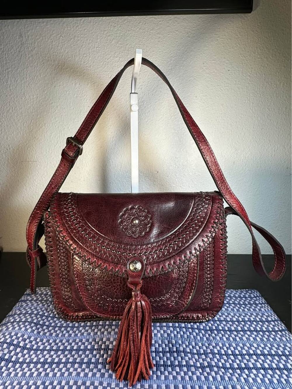 Patricia Nash Beaumont Tooled Leather Flap Bag with Tassel – Berry Red/Burgundy
